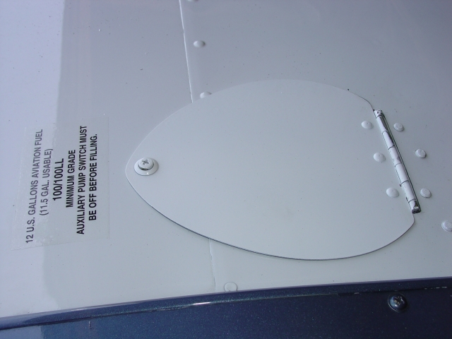 Fuel cap cover with placard
